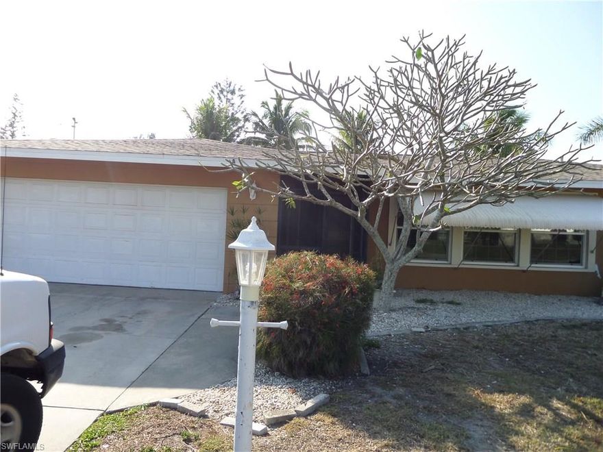 Great neighborhood in the much desired SW part of Cape Coral on a corner lot!  Three bedroom, three bath, two car garage house with an enclosed Florida room.   Walk in the front to the large living room on the right and straight to the family room to the left. Large open kitchen in the middle with pass through window and newer appliances.  Formal dining area leading to the spacious Florida room.  Large lanai surrounds the sparkling pool and hot tub, which you can enjoy after a day of play or work.  Walk in closets in the bedrooms, master has large remodeled bathroom shower, sink and closet. There is another bathroom in the garage.  This is a must see! Drive by and make your viewing appointment today.  We are in the process of cleaning up the landscaping, lanai, pool and solar system.  Come find your new home in our SW Fl Paradise.