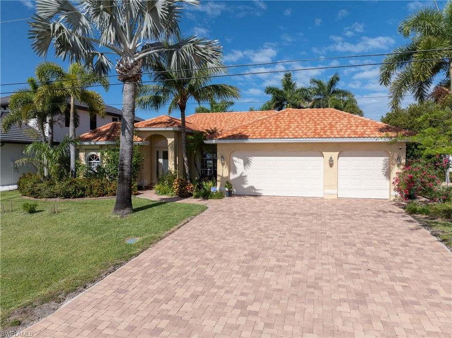 Don't miss this outstanding 4 Bed / 2 Bath Gulf Access Home Pool Home, with a 3 car garage, located in one of the most popular and desirable areas of SW Cape Coral just off of Beach Pkwy! This custom home features a gorgeous, new barrel tile roof in 2023, lush, mature landscaping and paver driveway giving this home great curb appeal!  Inside you have
 neutral tile throughout, tray ceilings, planters shelves and dining area overlooking the pool! The kitchen features granite counters, stainless steel appliance package, bar and cheery wood cabinetry! The master bedroom has French Doors out to the pool and the master bath has his and her sinks, with a granite countertop, and a huge tiled shower with two shower heads! The 2nd bedroom also offers French Doors out to the pool and would make an excellent office/den as well. The custom, oversized vanishing edge pool and spillover spa offers a Pebble Tec finish with Pentair remote control automation, attractive paver pool deck, and two built-in planters all under the huge screen enclosure! Enjoy your evening sunsets while entertaining looking down your long water canal view, and the convenience of your outdoor shower with an easy access pool bath! Electric roll-down shutters, AC new in 2017 and great rental history too!