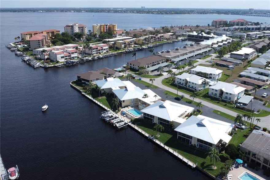Direct deepwater/sailboat Gulf access condominium! Conveniently located in South Cape Coral, Villa Lisa offers the perfect blend of navigable waterfront living and close proximity to some of the area’s best dining, entertainment, and outdoor activities. This 2-bedroom, 2-bathroom 1st floor end-unit provides direct Gulf access via the Caloosahatchee River, making it ideal for boating enthusiasts, while also being just minutes away from vibrant local hotspots. Enjoy the peace of mind of a new metal roof recently installed plus the added benefit of a covered deeded carport and separate 5 x 8 ft. private storage unit. Villa Lisa Condo sits along the 200 ft. wide Plato Canal and features just 4 buildings consisting of 4 units each with a central community pool, community boat docks & kayak launch for exploring the waterways. Steps from your door, you'll find Jaycee Park, a nearly 12-acre waterfront public park currently undergoing a major renovation and is set for completion later this year. The park’s scenic location along the Caloosahatchee River makes it a popular spot for kayaking, paddleboarding, and fishing. The $16–$18 million project includes a new bandshell, food truck court, bistro, new playgrounds, splash pad, covered pavilions, and a boardwalk. A designated concession area, "The Reef," will serve food, beverages, and alcohol within a specific zone. These upgrades aim to transform the park into a vibrant community hub. Cape Coral also boasts a dynamic arts and entertainment scene. The Cultural Park Theatre showcases an array of performances, from classic plays to high-energy musicals, while concerts and live events are regularly hosted at venues throughout the city, including Cape Coral’s new amphitheater. Additional area amenities include upscale shopping, dining and live music events at Cape Harbour, as well as, the Cape Coral Farmers Market which is held every Saturday. Outdoor enthusiasts will find endless opportunities for recreation nearby. For those looking to explore nature further, the Four Mile Cove Ecological Preserve offers a 1.2-mile loop trail through mangroves, perfect for birdwatching and peaceful nature walks. Families can enjoy thrilling water slides and lazy river rides at SunSplash Water Park, while adventurers can take a boat trip to Cayo Costa State Park, home to pristine beaches and lush hiking trails. Whether you’re looking for boating access, waterfront tranquility, or a vibrant social scene, Villa Lisa Condominium puts you right in the heart of it all. This is more than just a home—it’s a gateway to the best that Cape Coral has to offer.