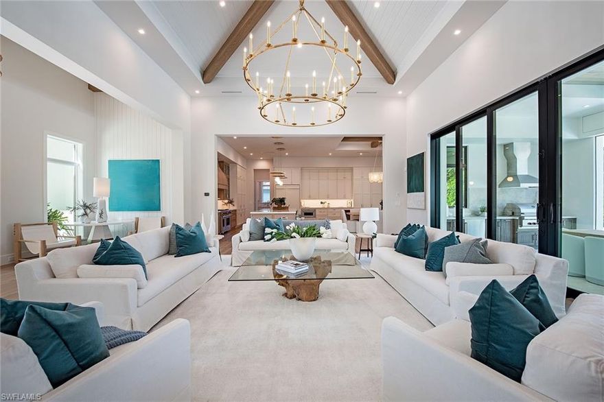 New construction in X-500 flood zone, a luxurious transitional oasis! Enter the grand foyer of this exquisite five-bedroom, five-bath residence, and be immediately enamored by its breathtaking vaulted ceilings and the seamless flow between indoor and outdoor spaces. This stunning home in the Moorings showcases distinctive architectural details that elevate its charm and sophistication. Prepare to entertain in style in the gourmet kitchen, equipped with elegant quartz countertops, state-of-the-art appliances, a built-in pantry, wine cooler, and refrigerator drawers. The spacious center island, complete with a breakfast bar, is ideal for gatherings and culinary delights. Throughout the home, you’ll find exquisite porcelain tile and white oak wood flooring, complemented by solid-core 8-foot interior doors. Modern conveniences abound with a generator, a built-in Sonos music system and pre-wiring for security cameras, marrying elegance with cutting-edge functionality. The expansive owner's suite is a retreat, featuring quartz countertops, a relaxing soaking tub, two beautifully designed walk-in closets, and private water closets for added privacy. Enter into the magnificent great room which opens seamlessly to your secure outdoor living area, complete with a stunning swimming pool and spa. Enjoy alfresco dining in the fully equipped summer kitchen, cozy up by the gas fireplace, and relax on the outdoor patios or under the covered lanai, featuring automated insect screens and hurricane-rated shutters. Ideally just a short distance from the beach, restaurants and shopping, this remarkable home also offers the opportunity for membership to sought-after Moorings Private Beach Park. Crafted with precision and elegance by Lutgert Construction, this residence is a blend of luxury and lifestyle. Your forever home awaits.