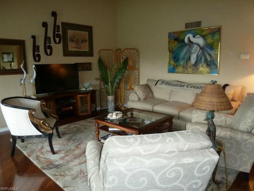 All you need are your golf clubs to move in and start living the life. This furnished 3 bedroom, 2 bath Highlands second floor corner unit is beautifully appointed with new kitchen and baths, new cabinetry, new counter tops, very nice tile in wet areas, newer appliances, fixtures, lighting, cherry wood flooring and plantation shutters. This unit has great extra space with the third bedroom/loft. Enjoy the Florida breezes from this screened lanai overlooking the golf course and lake of the #13 hole of the Wee Friendly Golf Course.   New washer and dryer and hot water heater. A/C unit only 2 years old.  Outside storage closet in carport. Carport also has outlets to plug in your golf cart. Fiddlesticks offers 36 holes of championship golf with very low density, complete practice facility, har-tru tennis courts, staffed fitness center, clubhouse with fine dining year round. Own your own golf cart here. $81,000 Golf Equity membership due at closing. No CDD fees.