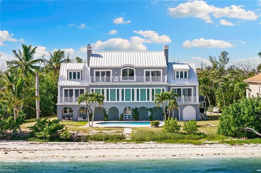 Experience the pinnacle of coastal living with this extraordinary 5,542-square-foot beachfront residence on Sanibel Island. Positioned on a private .86-acre lot adjoining protected conservation land and boasting 150 feet of waterfrontage. Designed for elegance and comfort, this four-bedroom estate captures sweeping bay views from nearly every room, the home features gracious living and dining areas with a fireplace and walls of glass that open to breathtaking panoramas. The expansive layout includes an inviting spacious kitchen with wide water views, a luxurious and spacious primary suite, a private office, and a serene sitting room to enjoy bay views, all accentuated by timeless hardwood flooring and impact-rated windows and doors. The top floor houses guest suites and a second primary suite. Gi outside to an inviting heated beachfront pool overlooking the wide bay, an ideal setting for tranquil relaxation or refined entertaining. With unmatched privacy, stunning natural surroundings and potential to create a private world-class single-family retreat, this property offers an exceptional opportunity to own one of Sanibel Island’s desired waterfront addresses. The home received damage to the lower non-living area during Hurricane Ian, the pool and garage have been restored, but storage areas, landscape and irrigation system requires repairs and updates. The home is in the sought-after area of Bird Lane within a few minutes of the Sanibel causeway and bridge for easy access on and off the island and offers incredible potential for updating and personal touches. The home is being offered in as-is condition.