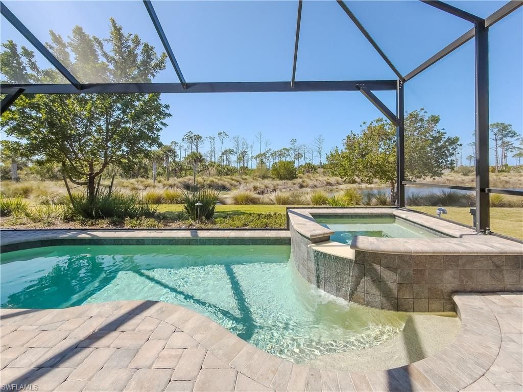 Photo of 6399 NEGRIL ISLE DR, NAPLES, FL 34113 (MLS # 226009325)