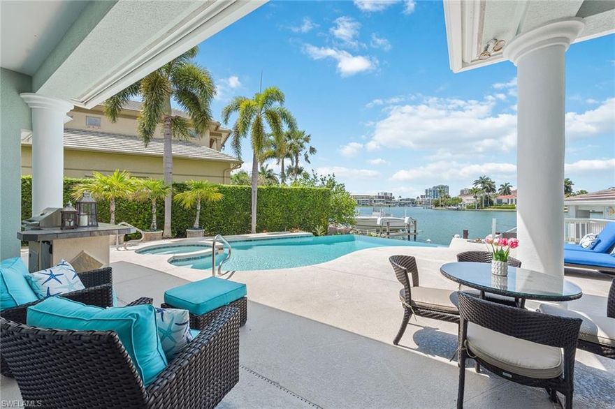 This charming waterfront home is ready for you to start enjoying the Naples lifestyle this season! Recent enhancements include: all new carpeting and interior paint, new air conditioner, new pool heater and pump, two new water heaters, and new landscaping. The home features a bright and open layout that showcases beautiful bay views and features such as volume ceilings, elegant limestone flooring, a large kitchen featuring gas cooking and solid wood cabinetry, a gas fireplace and wet bar in the living room, large guest bedrooms, a convenient den/office just off the foyer, and a three-car garage. The expansive master suite offers bay views, two large walk-in closets with built-ins and a private courtyard. Outside, the sparkling infinity edge pool and spa make a wonderful first impression as it draws you to the welcoming dock below and expansive bay views beyond. The home’s boathouse is a rare and welcomed addition, featuring a boat lift and easy access to the bay. Located within a short distance to the beach, access to Moorings private beach and just minutes from the shopping and dining at Venetian Village and Old Naples.