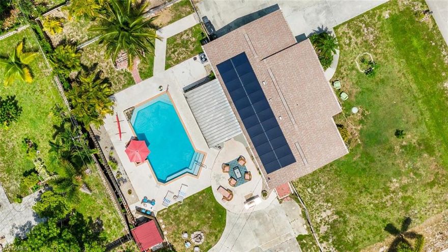 Welcome to the ‘Turtles Nest’ your canvas of opportunity nestled in the desirable community of San Carlos Park at 9208 Hamlin Rd East! Situated on a sprawling, lush TRIPLE lot, this 3 bedroom, 2 bathroom home has tons to love! Updates include: NEW ROOF (2021), NEW AC (2021), and SOLAR PANELS (2021) ensuring comfort and energy efficiency.  Open the screened-in entryway and discover a delightful spot to savor your morning coffee. Once inside, the entrance reveals a generously proportioned, well-lit living area that emanates an airy and open feel.  Enhancing convenience, the inclusion of a side-door entry grants you access to your very own mud room, thoughtfully equipped with a pantry, ample storage space, and a convenient laundry area.  Tile throughout the home, NO CARPET!  The Primary Bedroom's bathroom also has access to the outdoor space behind the home. The backyard is an oasis of its own, with one of the largest saltwater in-ground pools in the neighborhood complete with a stone waterfall. As an added touch of luxury, the pool features an interior table with its own seating, all immersed within the crystal-blue waters.  There is an abundance of open space in the backyard, featuring enticing additions such as a cozy fire pit, a secure fenced area for your beloved pets, and tons of space to lounge, grill, and enjoy outdoor meals. With its expansive lot, and some TLC, this property holds immense value and limitless potential, making it an ideal investment for those seeking both space and opportunity.  Plenty of room to park your boat, build a 2-car garage, carport, or workshop! No Flood Zone! No HOA! Property is in an opportune location on a quiet street, close to RSW Airport, Beaches, Shopping, and I-75! Nestled in the southern section of San Carlos Park, this property sits adjacent to Estero, offering a convenient location that is only a short 15-20 minute drive to the charming city of Naples. INVESTORS CAN AIRBNB, No rental restrictions! Schedule your showing today!