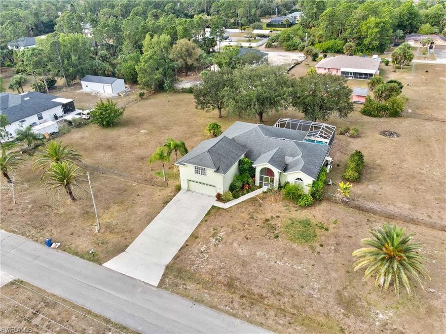 Welcome to 715 Plumosa Avenue in Lehigh Acres! This thoughtfully maintained 5-bedroom, 3.5-bath home with close to 3,000 square feet offers the ideal blend of functionality, space, and Florida lifestyle. This is a one-story home with an upstairs bonus, allowing all main living areas to remain conveniently located on the first floor. The property features a beautiful pool with a screened lanai, perfect for year-round enjoyment. A half bath is located directly off the under-truss lanai, making it ideal as a pool bath for entertaining and everyday use. Recent updates include a newer pool pump and a generator outlet added at the lanai for added preparedness. Upstairs, you’ll find a massive bonus room with a full bathroom, offering exceptional flexibility. This space can easily serve as a home office, mother-in-law suite, recreation room, or versatile flex space, all while keeping the rest of the home functioning as a true single-story layout. Additional highlights include a whole-home reverse osmosis system, high-speed internet availability, and key replacements since 2020 such as the dishwasher, washer, dryer, water heater, and RO water system. For added peace of mind, the home did not flood during Hurricane Ian. Situated on an oversized half-acre lot, the backyard is enhanced by mature oak trees and a desirable western rear exposure, allowing you to enjoy stunning Florida sunsets from your pool and lanai. Located in a quiet Lehigh Acres neighborhood with convenient access to shopping, dining, and major roadways, this home is a rare opportunity to own a spacious, well-upgraded property with privacy, flexibility, and outdoor appeal.