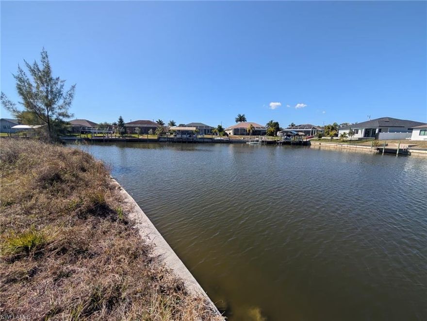 Discover the perfect location to build your dream home on this 12,200 square foot oversized gulf-access waterfront lot in beautiful SW Cape Coral. Situated on a basin, this property offers stunning water views down the wide basin, and the western exposure makes for amazing Florida sunsets. The lot features a brand-new seawall, saving you significant construction costs and giving you a head start on building. With extra space compared to standard lots, you'll have more flexibility for your home design, landscaping, and outdoor entertaining. Located in the highly desirable southwest area of Cape Coral, this property offers easy access to shopping, dining, schools, and all the amenities Southwest Florida has to offer. Whether you're planning to build now or invest for the future, this waterfront homesite is a fantastic opportunity.  The assessments are nearly paid off! Don't miss your chance to own a piece of boating paradise with an amazing basin view, western exposure, and a new seawall already in place on this gulf access property!