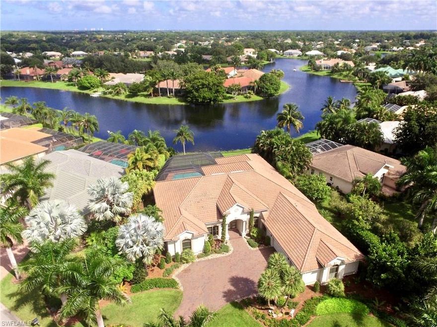 Gorgeous one-of-a-kind Rutenberg home built in 2000 on a professionally landscaped, oversized corner lot in beautiful Longshore Lake. This luxury home offers 4363 sf under air, 3 car garage, 4 bedrooms (all baths ensuite), full pool bath, a stunning chef's kitchen with custom cabinetry, pantry, and high-end appliances, formal dining room, home office, library, TV/Media room with surround sound, in-ground propane tank for gas range cooking, newer high efficiency HVAC & water heater, plantation shutters, motorized hurricane shutters, newly screened pool cage, built-in garage shelving, custom mahogany interior doors, custom closets, Hüper Optik solar window film, and more.  Enjoy sitting on the grand pavered lanai with the pool, lake, wildlife, and birds as a backdrop. Longshore is a premier gated single-family home neighborhood centrally located in north Naples at Immokalee Rd just east of I-75. It offers an active tennis program, fitness center, private clubhouse dining, and reciprocal golf with Quail Creek Village. The 88-acre lake allows pontoon boats & private docks. The newly renovated clubhouse offers numerous activities & events.  Low HOA fees at $320/month.