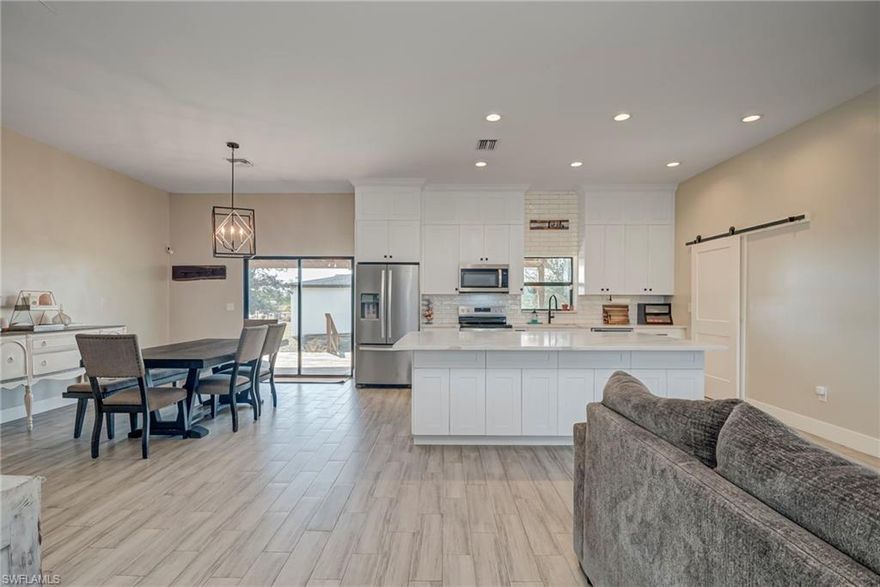 Discover this beautiful 1.25-acre property in a quiet area of LaBelle, featuring a spacious 4-bedroom, 2-bathroom home with an inviting open floor plan. The large kitchen is perfect for entertaining, complete with a generous island and plenty of counter space and accented by two charming barn doors that enhance the home’s country feel. Ceramic wood-plank tile flooring runs throughout, adding both style and durability. The primary suite offers a double-sink vanity and a walk-in shower. Practical updates include a roof and A/C unit that are only 6 years old. Outside, enjoy a fully fenced property with a yard irrigation system, a 1-car attached garage, a 30x40 detached 2-car garage, and a 30x30 carport—ideal for vehicles, storage, or hobbies. With no HOA, you’ll have the freedom to truly enjoy your space. This property blends comfort, functionality, and peaceful living—don’t miss the chance to make it yours! ****Seller to contribute $5,000 towards Buyer's closing cost with acceptable offer at closing, if offer is made within 30days from 1/10/2026****