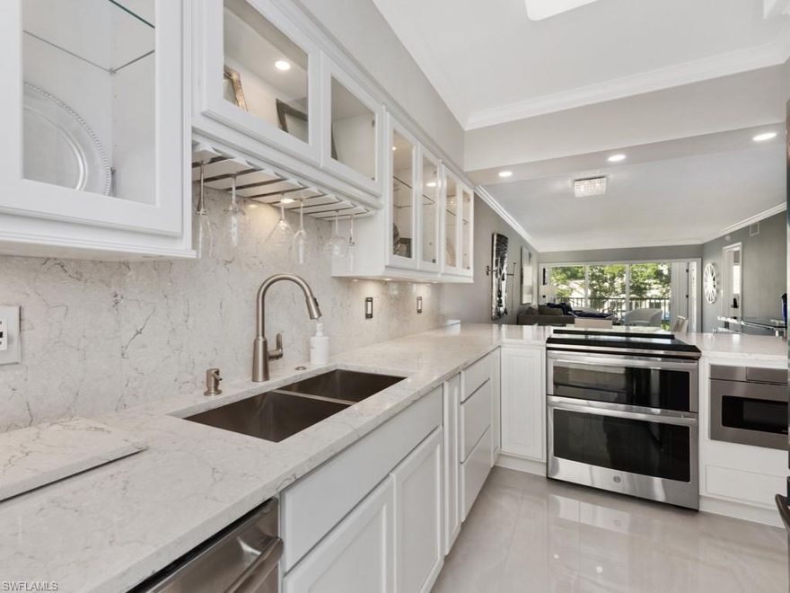 Want new construction a few hundred feet from the beach but cannot afford it??  This recently renovated and newly decorated condo feels like new construction at a fraction of the price.  This is a beautiful 2 bedroom, 2 bath unit   near the corner of Gulf shore drive and Beautiful Banyan BLVD. This is a high end renovation that was not done as a "FLIP".  It has over $100,000 in renovation costs.  Including gorgeous  White Kitchen with all new cabinets and Quartz counterops. New high end appliances and tile floors throughout.  All walls and ceilings were re-texturized, the windows were replaced with Hurricane cat 4 rated windows  The interior doors were all replaced with sold core.  All new trim throughout.  The screened lanai was remodeled and Hurricane Impact glass replaced the windows, the opening was expanded which extended  space and increased light into living room. Bathrooms have new tile, vanities and high tech bluetooth light fixtures. The shower doors were $2000 each and beautiful.   Banyan Blvd is one of the most beautiful streets in old Naples. Numerous restaurants, Naples Beach Hotel and the Edgewater Hotel are a short walk away. This home is a knockout!