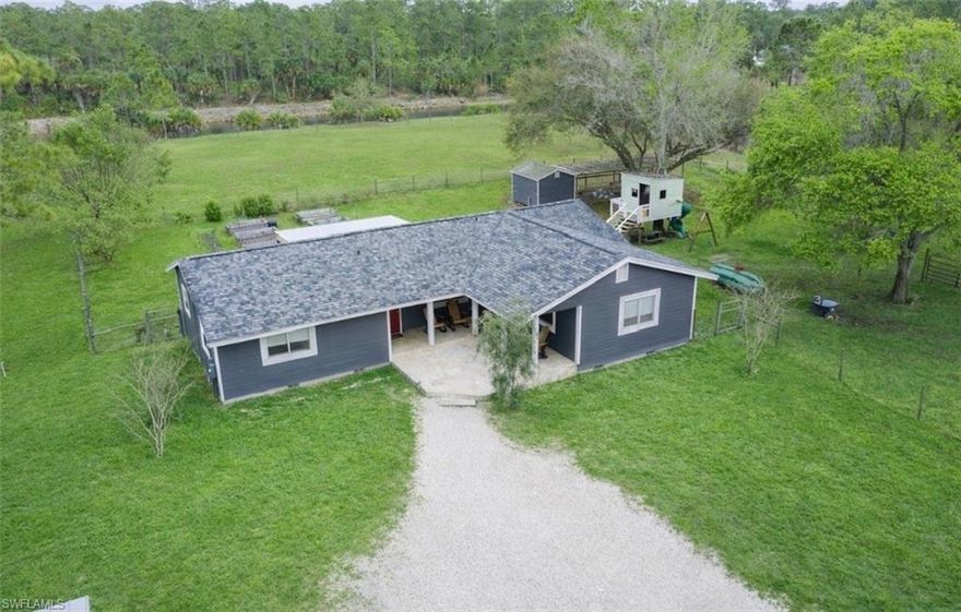 Welcome to peaceful rural living in this charming 3 bedroom, 2 bath home situated on over four acres. The comfortable split-floor plan features a spacious open kitchen and living area, perfectly positioned at the heart of the home. Recent updates include luxury waterproof vinyl plank flooring throughout, new baseboards and a whole house RO system. You’ll prepared for our SWFL summer storms with impact windows, whole-house generator and 500-gallon tank. Outside features Hardie Board siding, with a fresh coat of paint and six large raised garden beds ready for planting. The chicken coop is oversized, predator-proof and equipped with an automatic fan system to keep your flock cool at night. A newly built 40’ x 60’ metal shop building with a 15-foot door provides excellent enclosed and covered storage space for equipment, vehicles, or hobbies. The square-shaped lot is a rare find and allows for efficient use of the land. Fenced and cross-fenced, this property is ready for animals. With room to grow and plenty of space to enjoy the outdoors, you'll find the peace, quiet, and the country lifestyle you’ve been looking for.