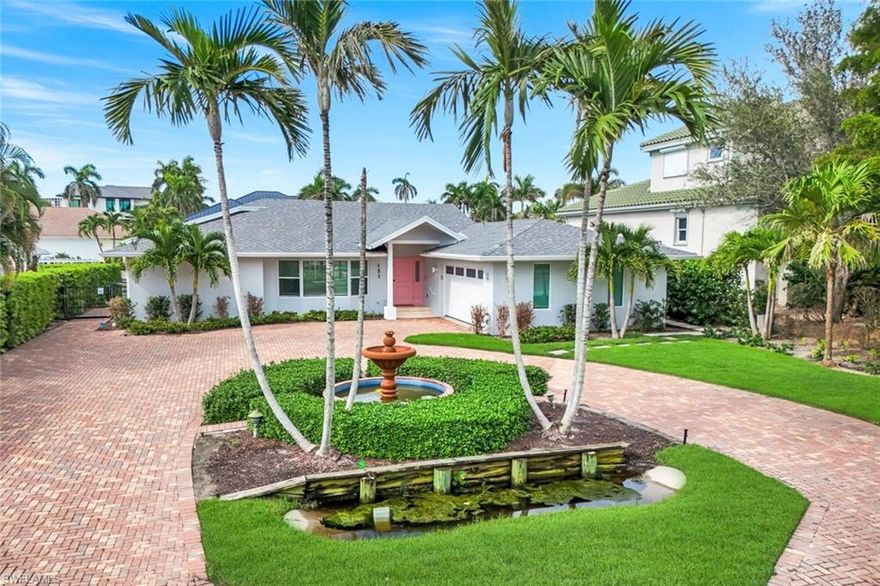 WALK TO THE BEACH AND HAVE A BOAT IN YOUR BACKYARD! This spectacular and move-in ready, three bedroom and three full bathroom, waterfront home offers the best of both worlds in Florida living! Enjoy boating right outside your door and private beach access to miles of soft white-sand and sparkling emerald waters just footsteps away. An expansive and bright, great room floor plan is the highlight of this completely updated home. Countless additional improvements include; marble and ceramic tile flooring, kitchen center island, quartz counters, and impact windows. The split bedroom floor plan mirrors a contemporary design, with ample room for the master suite offering his/her closets, water closet, separate French soaking tub and shower. The guest wing is conveniently located on the opposite side of the home. A set of newly installed, glass pocket sliding doors open the main living area up to the outdoor living space, creating the ultimate in entertaining for you and your guests! Owners will appreciate the prime location, within walking distance to LaPlaya Beach & Golf Resort and a short drive to the Ritz-Carlton Naples, Mercato and Waterside Shops.