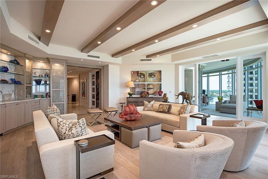 Enjoy gorgeous Gulf and bay views from this "front and center" location in Aria. Just steps to the beach, this beautiful home in the sky provides 5,000 square feet of luxurious living with 3 bedroom suites plus dual dens, 4 full and 1 half baths and 2 generously-sized outdoor lanais. Neutral coastal tones are evident throughout with beautiful hardwood floors, beamed ceilings, custom bar and various finishes. The updated kitchen features light cabinetry, Taj Mahal countertops, wine cabinet and ample storage. Additional features include nearly 10' ceilings, 8' doors, motorized shades, custom millwork, air-conditioned storage and 2 parking spaces. The building amenities include a social room, fitness room, billiards room, large pool and spa, two guest suites, a 24/7 manned front desk and a resident manager. Stroll to Venetian Village for dining, shopping and entertainment. Park Shore residents may purchase or lease a dock located across the street.