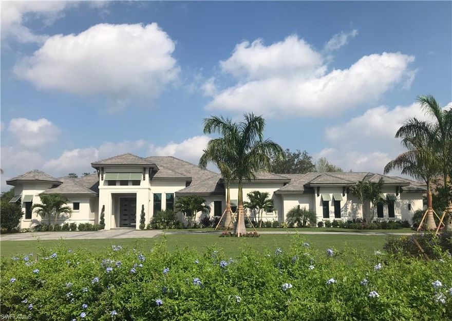 The St. John's MODEL by Florida Lifestyle is a four-bedroom, 4.5 bath open floor plan. Sitting on a lot that is over 1.2 acres, the St. John's features finely detailed ceilings including a barrel ceiling in the study, decorative coffers in the Great Room and Foyer and coffered ceilings with beams in the Master Suite.  Porcelain tile floors feature a wood inlay at the foyer, hallway and dining room. The kitchen features a grand island, butler's pantry, dual dishwashers and double ovens among other gourmet details. This plan features a wonderful indoor/outdoor connection to an expansive outdoor living area featuring a fireplace, summer kitchen and fire pit.  The luxurious pool and spa with water feature complete the ultimate package of Florida living.  This lot is located on the golf course with a water view.  Every detail is exquisite with Florida Lifestyle Homes' quality and attention to detail.  A $40,000 Builder credit toward the social membership is currently being offered..