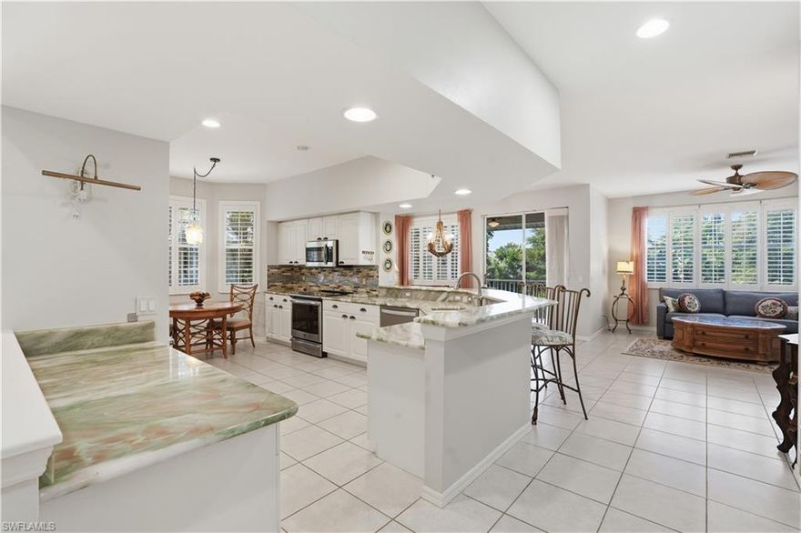 Welcome to this beautifully maintained second-floor condominium in the sought-after Spanish Wells community. This home, offered partially furnished, features 2 bedrooms PLUS a den, 2 bathrooms  and a large great room where kitchen, living and dining are open to one another. This light-filled end unit showcases offers many extras such as plantation shutters, gorgeous marble countertops in the kitchen and bathrooms, a spacious screened lanai perfect for enjoying peaceful water views and so much more!  The kitchen is well-appointed with stainless steel appliances, ample cabinetry, and a cozy breakfast nook. There is a more formal dining space just off the living area and access to a larg lanai where you will enjoy peaceful water and preserve views. The expansive primary suite features a large walk-in closet and an ensuite bath with dual sink vanity and a walk-in shower, while the split bedroom layout provides privacy for guests. Additional highlights include an attached one-car garage and close proximity to the community pool just steps away. Ideally located near shopping, dining, and all that the area has to offer, this home presents an exceptional opportunity for comfortable full-time living or a seasonal retreat. The Spanish Wells Country Club is available for both social and golf memberships, with no waitlist.  This home is lovely and could easily be your perfect home away from home!