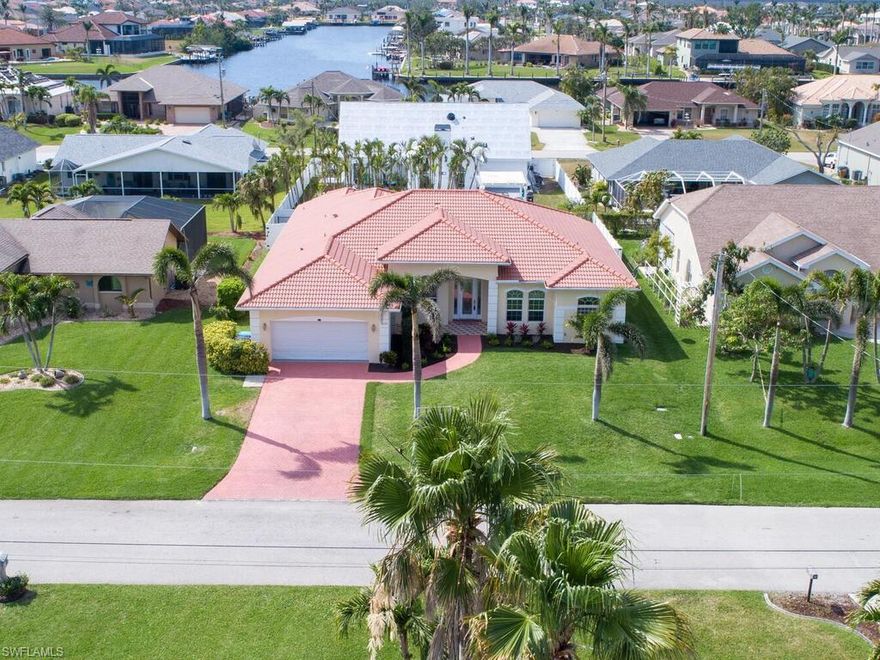 Perfection and privacy in paradise! Just shy of 2800 sqft, This custom home offers 3 bedrooms + den , 3 full baths, heated POOL, TILE ROOF, and an oversized 2-car garage! PRIME SW Cape Coral Location w/ WESTERN Exposure! As you enter, you are welcomed to 2 expansive great rooms w/ tall tray ceilings, LARGE kitchen w/ island featuring granite countertops and backsplash, custom cabinetry, newer appliances, and a custom built-in entertainment center! Spacious master suite with the softest carpet you've ever felt, sitting area overlooking your custom pool, large bath w/ dual sinks, tub & walk-in shower! Your 16x32 saltwater pool comes equipped w/ full automation, heater/chiller combo, HUGE sunshelf, and 3 waterfalls! ASSESSMENTS PAID IN FULL (city water/sewer)! Never flooded during the Hurricane, Flood Insurance assignable, Less then $700! WOW! Hop on your golf cart and ride down to Cape Harbour for great food and entertainment, or to launch your boat from the Marina! This exceptional home offers family and friends the ultimate Florida lifestyle. Call for your own private tour today!