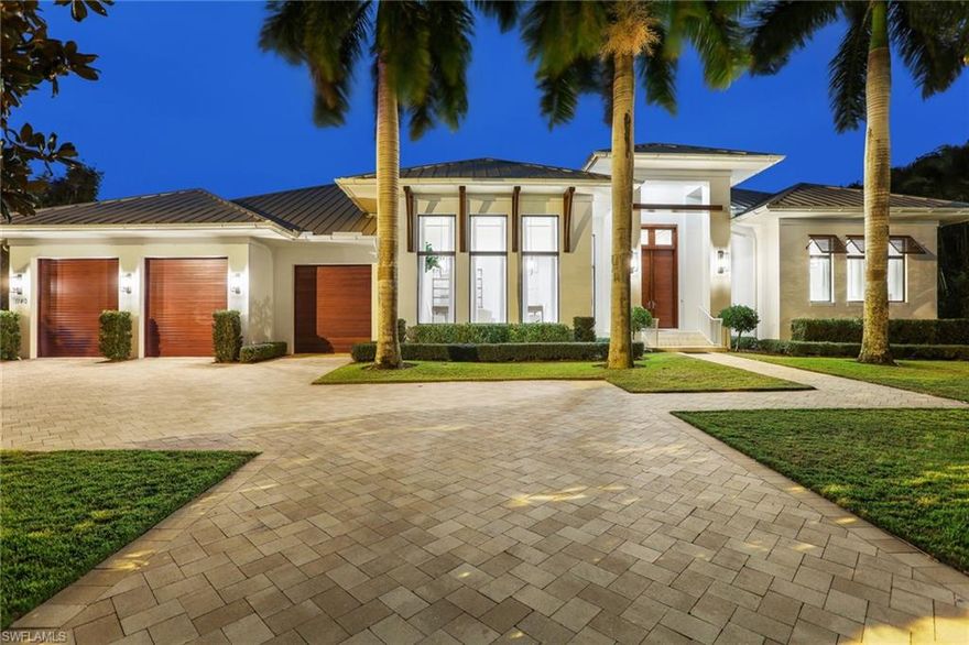 Discover the meaning of luxury living in this custom residence which is located just steps from the renowned sugar sand beaches that make Naples famous.  The 5 bedroom great room floor plan with 3 car garage is perfect for a large family or host who wants to have everyone under one roof! The home lives on a single level and has been finished to a level that will please even the most discerning buyer. Gourmet kitchen with custom cabinetry, an oversized island and a large pantry, top of the line appliances including wall oven, 2 dishwashers, and wine cooler. The family room opens to two covered outdoor living areas with electric screens, a summer kitchen, and an oversized pool & spa surrounded by lush greenery and over 60 magnolia trees that line the perimeter of the property. A large master bedroom with luxurious marble and large walk-in closet. Bedrooms have en-suite bathrooms. Stunning finishes throughout including marble & wood floors, high ceilings with detail, and impressive lighting. A tropical setting perfectly located for one who seeks the convenience of being close to the beach, shopping, dining, and cultural districts. A must see that will not last.