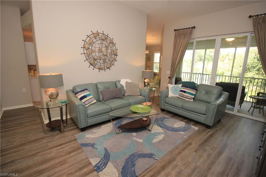 Free Golf Membership for remainder of 2019...NEW PRICE REDUCED! Amazing Golf course view from this 2nd Floor, 2 Car garage Coach Home. Open floor plan terrific for entertaining with updated flooring in living areas. Balcony view includes a water feature. Electric roll down shutter offers additional protection for  screened balcony.  Amenities include heated resort pool with spa, bundled golf, restaurant, fitness center, lap pool, pro shop, tennis courts, bocce court, pickle ball and driving range. Resort South Florida living at it's finest, conveniently located to SWF Airport, great shopping, restaurants and sandy beaches. Cypress Woods Golf and Country Club offers More information available @ http://www.cypresswoodsgolf.com/  This fantastic golf community boasts 18 hole Gordon Lewis designed Golf course.