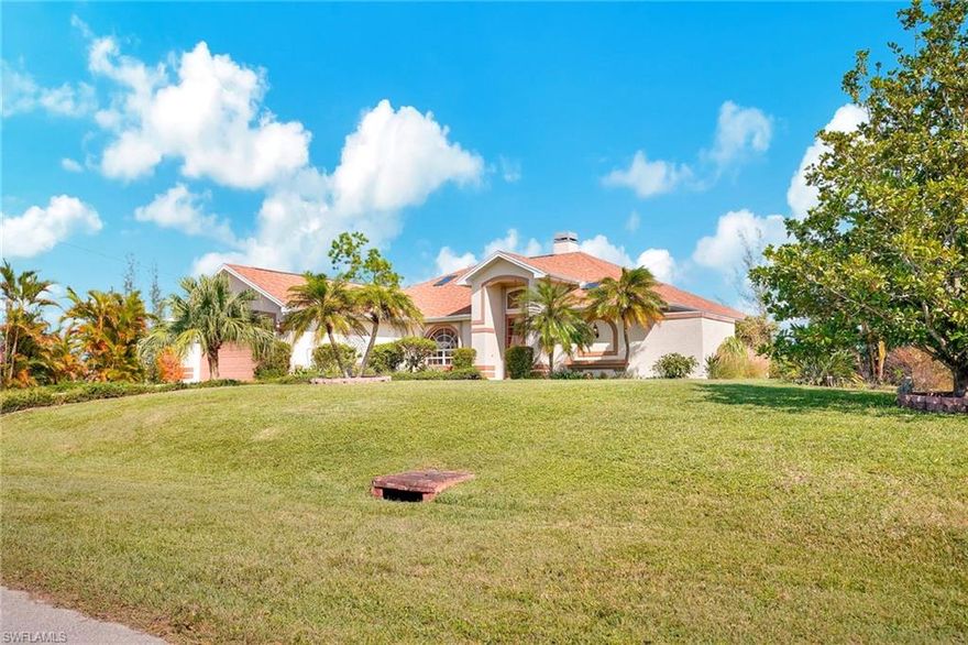 ENJOY PARADISE AND A MILLION DOLLAR VIEW FROM YOUR PATIO.  Reduced $35k!  Catch fish right off your own dock, or launch your kayak to explore the canals. THE TRIPLE LOT W/ LUSH LANDSCAPING, FRUIT TREES AND FLOWERING BUSHES PROVIDES THAT OLD FLORIDA FEEL. This feels like HOME!  From the beautiful brick flooring in the lanai to the warm glow of the fireplace, and the atrium shower in the master bath, you will not find these features in another home.  This unique home has 2/3 bedrooms, 2 baths and provides stunning, panoramic canal views right from your lanai, perfect for relaxing. Located in NW Cape Coral, this home offers the perfect setting to savor your morning coffee while watching the peaceful sunrise. Inside, the modern kitchen flows into the open living room, where a radiant gas fireplace adds comfort and charm. The master bedroom suite offers sliders to lanai, dual sinks and a unique atrium-style shower, bringing a touch of nature indoors. The versatile 3rd bedroom can serve as an office or IN-LAW suite, complete with its own small kitchen area and sliders to its own private lanai. Outside, the side yard offers ample space for a future pickleball court, while the backyard has plenty of room to add a pool, enhancing the outdoor lifestyle options. Located in a quiet, growing neighborhood, this property offers privacy and tranquility with calming water views. It's 15 minutes to Burnt Store Marina and Matlacha plus easy access to shopping, dining, boat ramps, fishing spots, I-75, Punta Gorda Airport, and the highly anticipated Seven Islands Project and Future Tropicana Park & Festival Park.  Best of all, it's located OUTSIDE the flood zone, so you can fully enjoy the beauty this home has to offer with complete peace of mind.