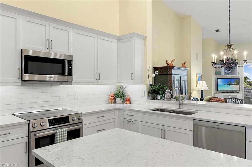 Perched on the top floor with soaring ceilings, this furnished three-bedroom, two-bath Breakwater residence delivers that bright, breezy Pelican Bay feeling the moment you walk in. Experience the essence of Naples beach resort living with a beautifully renovated kitchen and wood-look hard surface flooring throughout, creating a clean palette that's as low-maintenance as it is stylish, and making move-in truly effortless. Outside, the view is pure Naples as you look across an expansive lake to Pelican Bay Community Park, where mornings come with walkers, cyclists, and that easy vacation every day energy, all enjoyed in peaceful comfort from a generous screened balcony with electric grill and rolldown storm shutters. Breakwater offers oversized, private two-car garages, an uncommon luxury in Pelican Bay. Breakwater amenities include a gated entrance, clubhouse with pool and spa, and social and exercise rooms, and charming brick-paver streets. Pet owners love Breakwater's pet-friendly policy and enjoy all the perks of the Pelican Bay lifestyle, including a private beach club on the Gulf with two beachfront restaurants, beach attendant service, miles of pristine beaches with exclusive access, canoeing and kayaking in picturesque Clam Bay estuary, two tennis centers, pickleball, and fitness and wellness center. Exceptionally just minutes to Mercato and Waterside Shops vibrant dining and shopping scene as well as Artis-Naples offering a premier cultural experience, featuring world-class music, visual arts, and performances as the home of The Baker Museum and the Naples Philharmonic. Ideal for buyers who want a furnished retreat with an active setting, elegant updates, and the simplicity of arriving with a suitcase and starting season on day one.