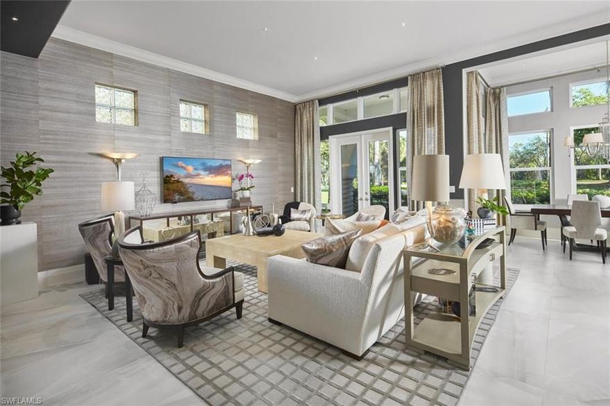 This exquisitely curated 4-bedroom, 4.5-bathroom completely remodeled home in the heart of The Colony offers a masterclass in coastal elegance and architectural sophistication. From the moment you enter, the home captivates with an airy, open-concept design defined by soaring 14'ceilings, floor-to-ceiling windows, and refined finishes that invite the lush Florida landscape inside.
Designed for those who refuse to compromise on style or substance, this residence isn't just a home, it's a sanctuary where every designer detail has already been perfected.The grand living area serves as the centerpiece of the home, featuring designer wall treatments and a seamless flow into the dining space, perfect for hosting intimate dinners or large-scale gatherings. Natural light pours through expansive glass doors, highlighting the large scale tile flooring that runs throughout the main living areas.
The dream kitchen is a culinary masterpiece, centered around a massive waterfall island and framed by a majestic arched entryway. High-end features include custom white shaker cabinetry with integrated lighting, premium stainless steel appliances and a professional-grade vent hood and a picturesque arched window overlooking the tropical grounds.
The primary wing is a private retreat defined by understated elegance. Wake up to serene views through expansive windows, or step directly onto the master terrace to enjoy the morning breeze. The spa-like master bath is a sanctuary of its own, featuring dual floating vanities with sleek hardware, deep soaking tub and a massive frameless glass rain shower and bespoke wall coverings and striking fixtures.
Step outside into your abundant private veranda. The outdoor space features a custom stone waterfall fountain that cascades into a heated spa and pool. Overlooking a serene lake with a central fountain, the primary terrace and patio areas provide the perfect backdrop for evening cocktails and sunset views.

Exceptional Details include architectural arches and high ceilings that enhance the sense of volume.
Lush tropical landscaping surrounding the property for maximum privacy, private elevator, new hurricane impact windows and doors and new roof in 2025.
Why wait months for renovation when perfection is ready right now? This captivating estate is offered fully realized and move-in ready, allowing you to bypass the process and proceed straight to the lifestyle you’ve earned. Living at The Colony includes private membership to The Bay Club,formal and informal dining and events. Access to a PRIVATE BEACH PARK, a huge tennis program, canoeing/kayaking, sailing club, bocce &pickleball, the list goes on! Elective private golf options. The Colony is a quick jaunt to the airport and just a mile and a half to great dining and shopping.