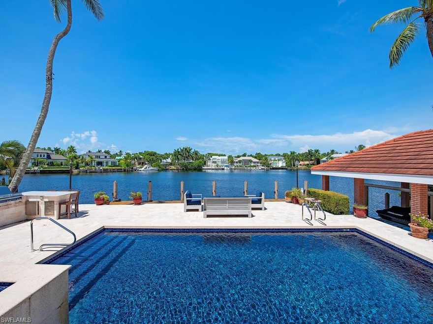 Rarely available, this desired location overlooking Aqua Cove is only a few blocks from the beach and everything 3rd Street South has to offer. Western rear exposure with stunning wide water views. Large 60' dock plus a grandfathered and coveted boathouse with lift. This home has 4 bedrooms + den, 4 full baths and a 3-car side-loaded garage. Impeccably maintained with numerous updates including a double island gourmet kitchen, full in-home bar, gorgeous bathrooms, redone pool, pool deck, outdoor kitchen and more.
