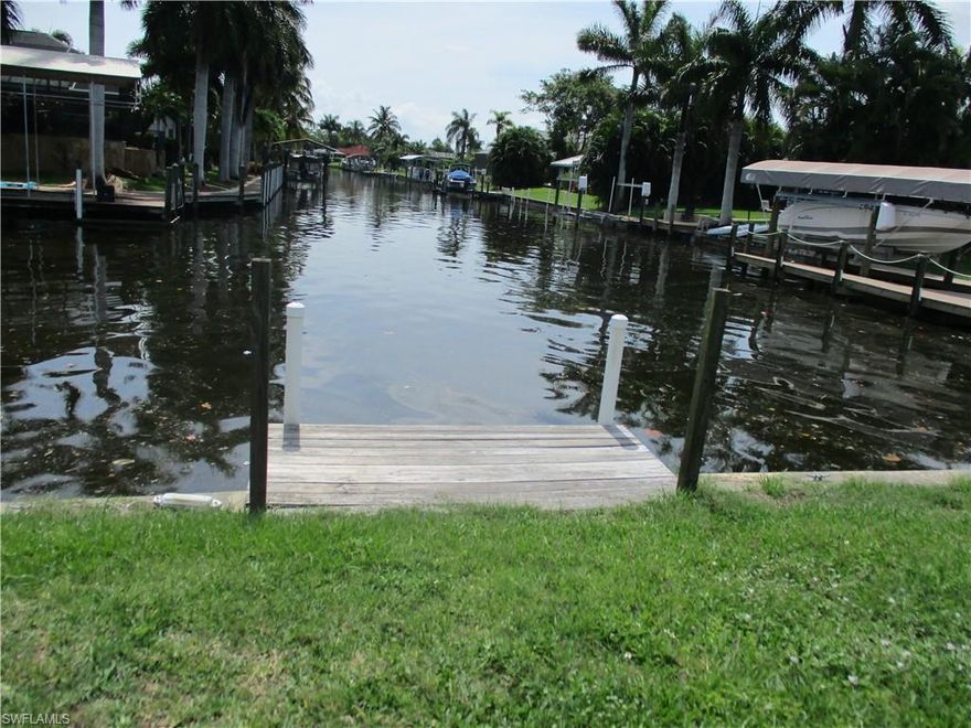 LOCATION, LOCATION, LOCATION....3 lot site on intersecting canals in popular Yacht Club area.  Minutes to river by boat with one bridge.  4 bedroom/2 bathroom.  Newer kitchen with stainless steel appliances & breakfast bar. Tiled great room looking onto screened pool & intersecting canals.  Outside storage building by pool.  Close to community pool, beach, boat ramp, tennis courts, handball courts, senior center, marina, banquet hall, children's play area on beach, & waterfront restaurant on beach.