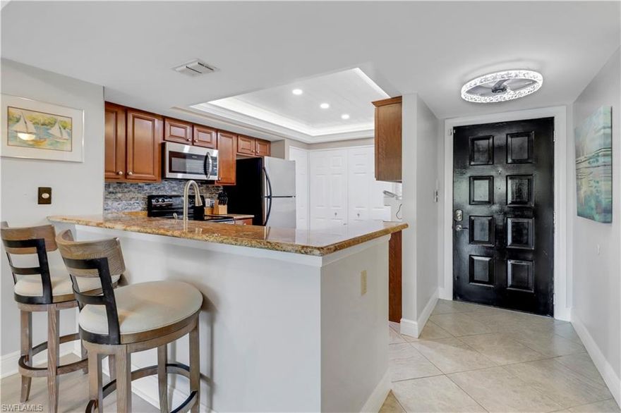 Welcome to coastal sophistication at Stevens Landing, one of Marco Island's most coveted waterfront communities. This exquisitely updated
two-bedroom, two-bathroom condo effortlessly blends elegant design with serene island living. A boater's paradise, it offers direct Gulf access,
your own complimentary boat slip, and an exclusive private fishing pier—perfect for enjoying Florida’s captivating waterways. The open-concept
floor plan is bathed in natural sunlight and accented by upscale finishes. The gourmet kitchen is a chef's delight, boasting rich granite
countertops, stainless steel appliances, custom cabinetry, an artfully designed backsplash, and an illuminated tray ceiling. Wide-plank bleached
oak and stylish tile flooring, paired with designer lighting fixtures and elegant crown molding, elevate the coastal chic aesthetic. Retreat to the
luxurious primary suite, complete with dual vanities and a sleek, tiled walk-in shower. The spacious guest bedroom features thoughtfully crafted
custom built-ins, offering ample storage and the ideal home-office space. Additional upgrades include electric blinds, impact-resistant doors,
and a newer AC and water heater, ensuring both convenience and peace of mind. Relax and unwind on your expansive, enclosed lanai
overlooking Stevens Landing’s lush, tropical landscaping—an idyllic space for savoring morning coffee or peaceful sunset evenings. Community
amenities offer a resort-inspired lifestyle, featuring a heated pool and spa, tennis courts, and a scenic nature boardwalk guiding you directly to
your private boat slip. Situated moments away from Goodland's charming waterfront dining, quaint cafés, and boutique shops, this residence
promises unparalleled island living. Don’t miss this rare opportunity to own a meticulously upgraded retreat where luxury and tranquility meet.
Your Marco Island paradise awaits!