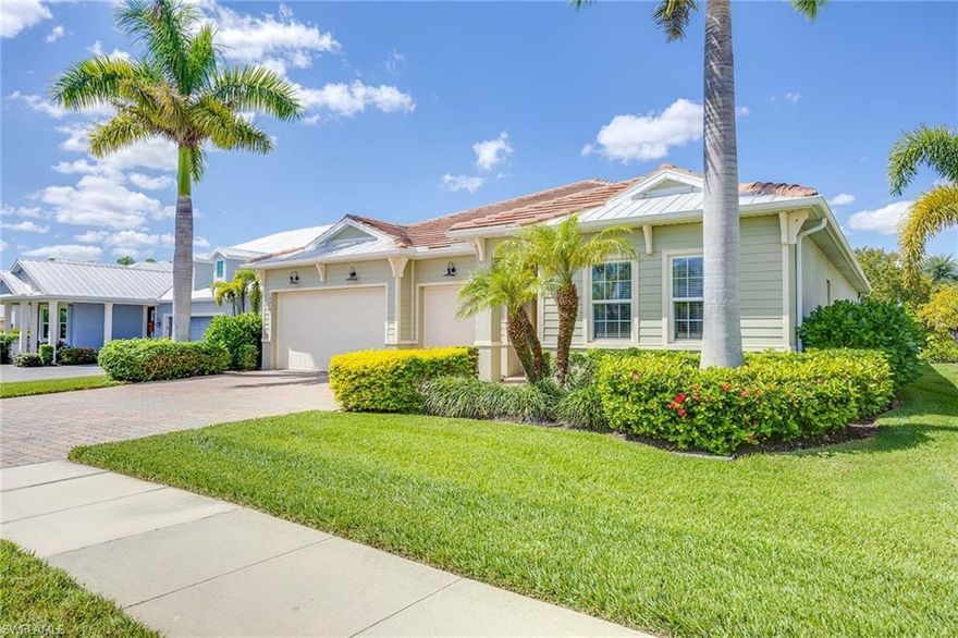 In Naples Reserve, this coastal-inspired ranch residence captures ease of resort living with 3,368 square feet of total space, a three-car garage plus an oversized corner home site. Built in 2018 and lightly enjoyed as a seasonal retreat, the home offers exceptional privacy, lushly landscaped views and polished feel of a property that has been meticulously maintained. The open floor plan is tailored for elegant entertaining and relaxed everyday living, featuring three bedrooms plus a den, two full baths and one half bath. The primary suite is a private sanctuary with direct lanai access, dual walk-in closets and a spacious en-suite bath designed for comfort and convenience. At the heart of the home, the island kitchen showcases white cabinetry, stone countertops, a walk-in pantry and an adjoining dining area that flows effortlessly into the main living spaces. Tile flooring throughout the principal living areas enhances the home’s clean, coastal aesthetic. Walls of sliding glass doors open to an exceptional screened lanai that feels like a private resort. Here, a custom pool and spa with spillover, built-in outdoor kitchen, bar seating, and multiple areas for lounging and alfresco dining create the ideal setting for sunset gatherings, weekend entertaining and year-round enjoyment of the Naples lifestyle. Electric rolldown storm screens add ease and peace of mind. Ideally near the Island Club, the home enjoys close access to one of Naples Reserve’s celebrated lifestyle amenities. Naples Reserve is a gated, amenity-rich waterfront community designed for those who want every day to feel like a getaway. Residents enjoy a stunning lakefront clubhouse, beach-entry resort-style pool, state-of-the-art fitness center, tiki bar and café, tennis, pickleball and bocce, along with kayaking, paddleboarding and other on-water recreation. Miles of scenic sidewalks and outdoor fitness stations further enhance the community’s active, social atmosphere. Lawn care and landscaping are included in the low association fees, offering a lock-and-leave lifestyle with exceptional convenience. Ideally between downtown Naples and Marco Island, this residence offers effortless access to acclaimed dining, luxury shopping, white-sand beaches and the best of Southwest Florida living.