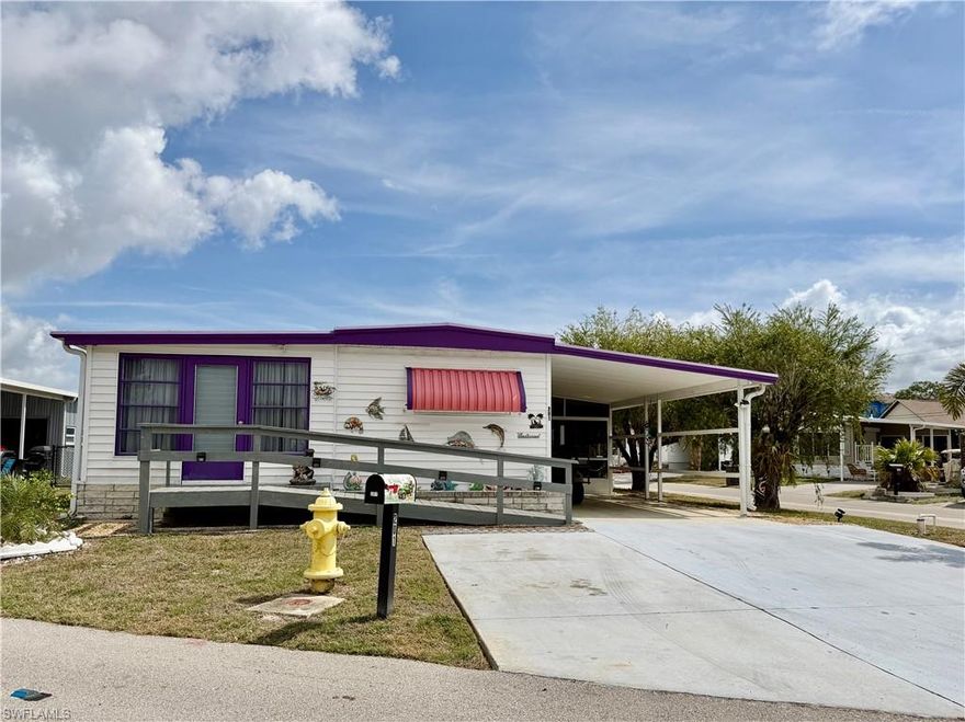 This charming home has 2 bedrooms, 2 baths and a bonus room with a split floor plan.  Turnkey, move-in ready home is situated on a corner lot with fenced yard.  Located in Carriage Village, an active 55+ pet friendly community.  OWN YOUR LAND and maintenance fee is $95/month.  Very wide driveway for extra parking.  Screened lanai for extra living space to enjoy our Florida weather.  Double doors give access for golf cart when needed.  New LVP flooring (2024).  Fence (2024).  Windows (2019) and has been replumbed.  Vapor Barrier (2020).  Utility shed with Washer (2021) & Dryer.  Wheelchair ramp accessible (2020).  Home has lots of natural light.  Survey available.  Freshly painted awnings around home for added sun and weather protection.  Golf Cart & Bikes included in sale. Community has so many amenities including large, heated pool, clubhouse, hobby shop, billiards, library and more.  Great place to live year-round or as a second home for warmer weather.