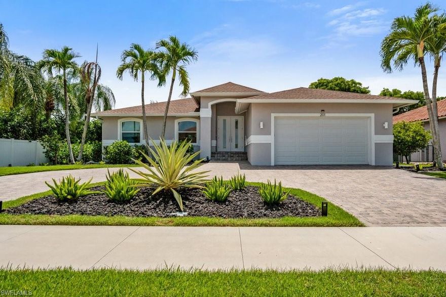 This fully remodeled and updated stunning Marco Island home is located on a quiet street in a very desirable neighborhood! Light, bright and airy 1,549 square feet with 3 bedrooms, 2 full bathrooms, and 2 car garage.  The custom sliding door opens up the entire family room wall into the huge screened lanai with outdoor kitchen adding tons of space for outdoor gatherings or lounging by the oversized pool and spa!  All new impact resistant windows and doors throughout. The eat in kitchen features a breakfast bar, quartz countertops, upgraded lighted cabinets, tile backsplash, lots of storage, and pull out shelves. Brand New Whole House Generator installed in 2021. All New Roof, A/C with UV, Screened Pool Enclosure, Windows & Doors were all installed in 2017.  Marco Island is surrounded by incredible white sand beaches, excellent fishing, and the most breathtaking sunsets in the world!