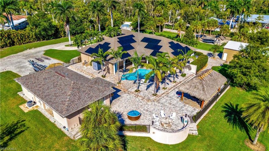 UNIQUE ESTATE PROPERTY w/ LUXURY FEATURES THROUGHOUT (see attached feature sheet)! Over 2.5 acres of land w/ 2 electric gates @ front entry-a grand main entry & an auxiliary (construction/landscape entry), wide paved driveway w/ circular area at front of main house (3113 sq ft under air, 5 beds+den, 3.5 baths), guest house (w/ 1083 sq ft under air, 2 beds, 2 baths, it's own washer/dryer & private rear lanai), huge parking area in front of attached 3-car garage, rock roadway completely around entire property (w/ parking area for guest house & wide driveway leading to a 4 car detached garage), and a large grass area that is currently used as the "playground" w/ play house & other children's activities. You will LOVE the almost 6,000 sq ft of outdoor living space that features a recently added resort-style heated saltwater pool & spa w/ rock water fountain & fire bowls, tiki hut w/ 2 tvs, built-in fire pit, spacious pool deck w/ pavers throughout, custom exterior lighting in pool, tiki hut, & on landscaping. The detached guest house is BRAND NEW and never has been lived in. The main house is gently used and meticulously cared for. In the past few years renovations in the main house include the master bath, closet systems, dining area(s), den, & bonus room. There is an Entire Home Solar System that saves hundreds in electric cost, and the RO system provides the entire home w/ quality water. Enjoy 3 zoned A/C systems (2 for main house & 1 for guest house). Current owners have really been able to update & bring a fresh high-end look to the property while creating an inviting atmosphere. The under-air living space, in addition to the massive outdoor living space gives you and your family a private retreat-oasis type of property that cannot easily be found! Located in Flood Zone X (No Flood Insurance Requirement). Situated in the highly desired Briarcliff neighborhood that is known for large parcels & estate home designs. Very convenient location- easy access to I-75, US41, & RSW airport, close to lots of shopping/dining options, and only a short drive to the beautiful beaches lining the Gulf!