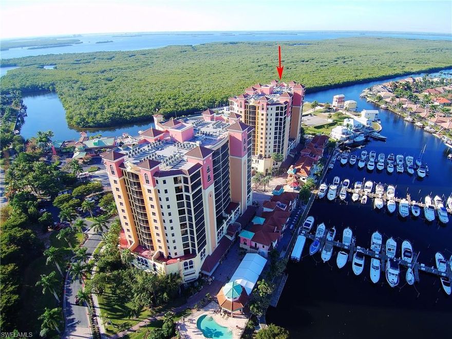 RESORT LIVING" on the Water.  Some of the best restaurants and live entertainment Cape Coral has to offer  are steps away from your lovely home with a view of a yacht-filled marina.  Two pools, a beautiful club house, tennis courts, basketball court, work out facility, miles of walking/biking paths, all await you with this lovely appointed, highly desirable Cayman Floor Plan Condo. 2BR/2BA fully furnished unit with split bedroom floor plan with ample parking in covered private garage. Large screened in lanai overlooking the marina extends from the living area to the primary BR. Washer and Dryer included. Just outside the resort within a mile offers more restaurants, sports bars, groceries, pharmacy, nail salon, banking options, donuts, and pizza. You will be spoiled by the convenience.  "NEW AC UNIT 10/6/25