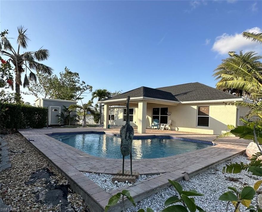 Pool House with Solar System in Cape ! Great location ! 4 bedrooms, 2 Bath and 2 car garage. Lanai under trusses with wood panels on the ceiling. Brand New Roof 2023.  Custom-built kitchen with granite , wood-plank tiles  through out the house, 6 inches base boards, spacious walk-in closet in the master bedroom, skylights shedding natural light in both bathrooms, professionally maintained CUSTOM salt water pool (2007), pavers on the oversized lanai, a shed in the backyard for storage.