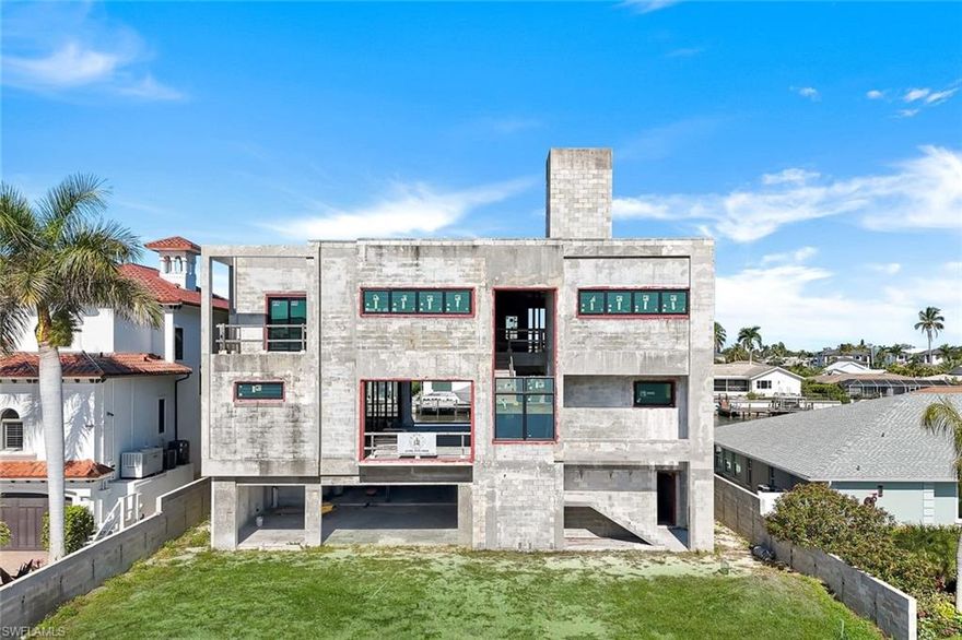 An extraordinary opportunity to complete a one-of-a-kind waterfront estate on the widest canal in Vanderbilt Conners! Just moments from the sugar-sand beaches of Vanderbilt. Positioned on an exceptionally wide parcel and constructed on pilings, this over 5,500 square-foot concrete offers discerning buyers the rare ability to fully customize a modern coastal masterpiece to their exact vision.

The home is already thoughtfully designed for grand waterfront living, featuring an infinity-edge pool, fire pit, privacy wall, and newly constructed seawall, all oriented to maximize sweeping water views and breathtaking sunsets. The expansive footprint allows for six or more cars in tandem, ideal for all the toys and car enthusiast! 

Set along one of the most impressive waterways in Conners, the property enjoys exceptional canal width and Gulf-access boating—creating a dramatic backdrop for elevated indoor-outdoor living. With windows, doors, and interior finishes yet to be selected, this residence invites the future owner to curate every detail, from luxury materials and bespoke millwork to a chef’s kitchen, spa-like primary suite, and refined entertaining spaces.

Surrounded by estate homes and offers both privacy and prestige. Just minutes to Vanderbilt Beach, the Ritz-Carlton, LaPlaya, Mercato, and Naples’ finest dining and shopping, this is an opportunity to save years of planning and permitting while still creating a fully custom personalized luxury waterfront retreat.

A truly exceptional offering where vision meets location, scale, and lifestyle—on one of Naples’ most coveted and widest waterways.