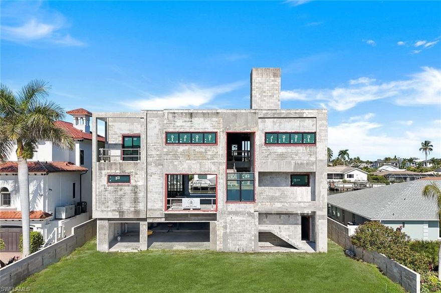 An extraordinary opportunity to complete this exceptional waterfront estate on the widest canal in Vanderbilt Conners! Just moments from the sugar-sand beaches of Vanderbilt. Positioned on a lot with exceptionally wide water views. Custom home boast over 5,500 square-foot and is constructed on pilings offering discerning buyers the rare opportunity to fully customize a modern coastal masterpiece to their exact vision.
The home is thoughtfully designed for grand waterfront living, featuring an infinity-edge pool, fire pit, privacy wall, and newly constructed seawall, all oriented to maximize sweeping water views and breathtaking sunsets. The expansive footprint allows for six or more cars in tandem, ideal for all the toys and car enthusiast! 

Set along one of the most impressive waterways in Conners, the property enjoys sparkling water views and Gulf-access boating creating a dramatic backdrop for elevated indoor and outdoor living. With windows, doors, and interior finishes yet to be selected, this residence invites the future owner to curate every detail, from luxury materials and bespoke millwork to a chef’s kitchen, spa-like primary suite, and refined entertaining spaces. Enjoy the ultimate in boating from your own backyard! 

Surrounded by estate homes and offers both privacy and prestige. Just minutes to Vanderbilt Beach, the Ritz-Carlton, LaPlaya, Mercato, and Naples’ finest dining and shopping, this is an opportunity to save years of planning and permitting while still creating a fully custom personalized luxury waterfront retreat.

A truly exceptional offering where vision meets location, scale, and lifestyle—on one of Naples’ most coveted and widest waterways.
