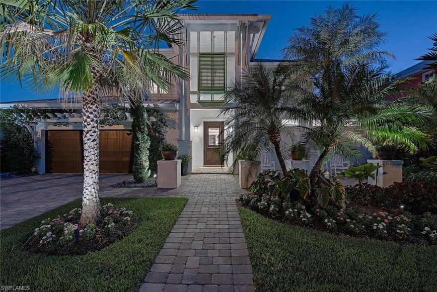 NO FLOOD OR STORM DAMAGE TO THIS SOUTHERN EXPOSURE POOL HOME IN OLDE NAPLES, JUST BLOCKS FROM THE BEACH! Don’t miss this exquisite, furnished home that has been recently updated. From the moment you walk through the door, you will be captivated. Expertly crafted by MHK Architecture, this home features beautiful flooring throughout, soaring ceilings in the great room, a cozy fireplace for relaxing evenings, and built-in shelving. The impressive, updated  chef's kitchen boasts an island and high-end appliances, seamlessly connecting to the dining and lounge areas, perfect for family and friends to gather.  The serene first-floor owner's suite provides private access to the lanai, along with separate closets and a new spa-like en-suite bathroom. Upstairs, you'll find a new morning bar and two beautifully designed guest suites, each with new en-suite baths and generous closet space. The office area is enhanced with sliding barn doors for added privacy. Outside, the meticulously designed space includes lush gardens, a welcoming front porch, and ample decking. Enjoy the pool and spa featuring LED lighting, a waterfall wall, and a trellised dining area and pool bath.  Additional features include a finished garage with plenty of storage, a widened driveway, and extra parking available directly in front of the residence. This fabulous home located in the heart of Olde Naples, walking distance to 5th Avenue South's, and 3rd Street South's fine dining, world-class shopping, entertainment, and white sand beaches … a must see!