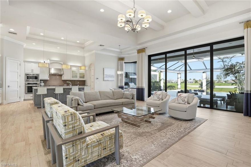 Set on nearly a third of an acre, this custom Harbourside residence offers a rare combination of newer construction, expansive lake views, and privacy within Talis Park. With desirable northwestern exposure, the home captures long water views and all-day sun across the infinity-edge pool and oversized outdoor living area, while maintaining a comfortable interior environment. Positioned near the owner’s gate for convenient access, the property stands out not only for its homesite size, but also for its more recent construction compared to much of the surrounding inventory.
The single-story layout includes three bedrooms plus a den and three and one-half baths, designed with clean architectural lines and an open great room concept. Soaring ceilings and walls of glass bring in natural light, while continuous tile flooring enhances the home’s cohesive, modern feel. The kitchen is both functional and well-scaled, featuring gas cooking, a large center island, walk-in pantry, and ample workspace for everyday living and entertaining. Impact windows and doors provide peace of mind, and the three-car garage offers substantial storage.
Outdoor living is a focal point, with an infinity-edge pool overlooking the lake, a full summer kitchen with gas grill and hot plate, and a generous deck designed to maximize sun exposure and usability throughout the day.
Located within Talis Park, residents enjoy a highly amenitized lifestyle with fitness facilities, resort-style pools, tennis, dining venues, a beach shuttle, and a robust calendar of social and wellness programming.