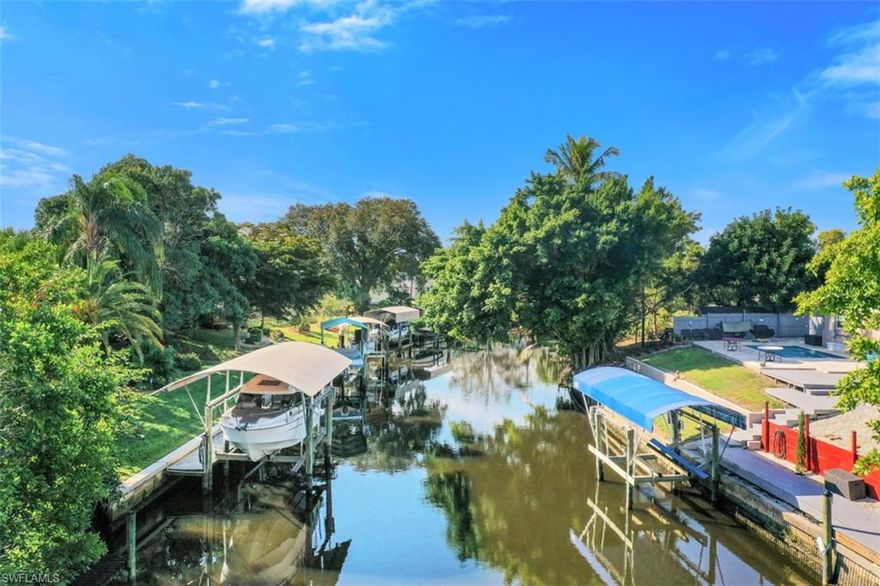 RENOVATED and classy 2+den home on a GULF-ACCESS canal in the GATED community of Palm Island is a boater's paradise, with 2 bridges and about 20 min to the river! 2020 ROOF, AC and interior paint. Travertine diagonal tile throughout. Enjoy your remodeled kitchen with quartz countertops, soft close cabinets, double oven, built in wine cooler, new appliances, greenhouse window above sink, pull out butcher block. More special features throughout. Owner's suite is a retreat! Open living area with dimmable recessed lights and skylights opens to almost 400 SF FL room, with removable window inserts for flow of fresh winter air. Step outside and your guests will not want to leave: open deck for more entertaining in a serene setting to watch famous FL sunsets and occasional manatee or dolphin in the canal below. Your private DOCK has water, 30 AMP electric and 10000 Lb LIFT with new cables, canopy frame and cover. Palm Island community offers resort style pool/spa, tennis court and clubhouse. Short drive to Ft Myers River District. LOW HOA FEE of $190/mo covers yard work, ext pest control and amenities access. No CDD or flood insurance. Watch video tour, take 3D walk-through, see in person!