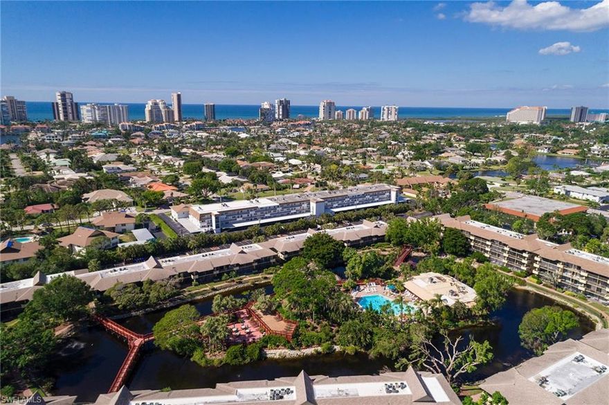 HUGE PRICE REDUCTION - This Condo-Tel is located in the very popular Park Shore Resort, west of 41, just blocks from the gulf.  Resort is set on a tropical island-like site.  Several wooden walkways connect condominium suites and resort amenities, stretching over circular waterway.  Turnkey 2nd floor unit has a split design – 2nd bedroom can be closed off with folding wall.  Foliage in front of screened lanai provides extra privacy. Swim, play tennis, enjoy our fitness room and shuffleboard, BBQ on our grilling patio or dine at our own Pate’s Island Club.  Investors – enjoy revenue sharing when placing your unit into PSR “Rental Pool.” Close to 5th Ave, Venetian Village, Waterside Shops, and Naples WHITE sandy beaches!