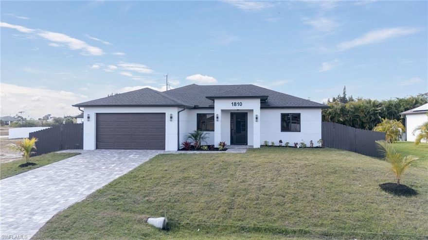 NEW CONSTRUCTION POOL HOME in Northeast Cape Coral! This beautifully designed 3-bedroom, 2-bath residence offers over 1,600 square feet of thoughtfully crafted living space and a 2-car garage with epoxy flooring.

The open layout showcases tile flooring throughout and a striking European-style kitchen featuring white cabinetry with bold black accents, stainless steel appliances, sleek modern finishes, and custom accent paneling for a contemporary touch. The living area is enhanced by an elegant TV accent wall that creates a stylish focal point. The primary suite offers a spacious walk-in closet and a designer bathroom with sophisticated black and white accent tile in the shower.

Enjoy true Florida living in the fully fenced backyard complete with a private pool featuring color-changing LED lights, a covered lanai, and a fully paved pool deck — ideal for relaxing evenings or entertaining guests. The driveway is also finished with beautiful pavers, adding to the home’s curb appeal. Impact-resistant windows and doors provide durability and peace of mind.

Conveniently located near restaurants, shopping, and schools, this home offers modern comfort in one of Cape Coral’s growing areas. Seller is offering buyer incentives with a choice of either a washer and dryer package or an outdoor kitchen countertop with sink, along with potential closing cost assistance.

Situated in an X flood zone — no flood insurance required — adding exceptional value to this move-in ready property.

Schedule your private showing today!