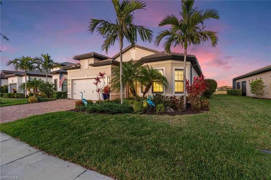 Welcome to this beautifully designed residence located within one of Naples’ most desirable gated communities. The open-concept floor plan is enhanced by volume and tray ceilings, plantation shutters throughout, and an extended driveway, adding both elegance and curb appeal. The spacious kitchen features granite countertops, a gas cooktop, wall oven, and ample cabinetry—making it both functional and inviting for everyday living and entertaining.

Impact-resistant doors and windows provide peace of mind while framing tranquil lake views. Step outside to the expansive covered lanai with a summer kitchen, ideal for outdoor dining, entertaining, or enjoying a quiet morning coffee. While perfectly suited for those who prefer low-maintenance living without a pool, the home is also pool-ready should you wish to add one in the future.

Tile flooring throughout enhances the home’s clean, modern aesthetic. The primary suite serves as a private retreat, offering dual sinks, a soaking tub, a separate walk-in shower, and generous walk-in closets. A thoughtfully designed laundry room with built-in cabinetry and a sink adds everyday convenience.

Residents enjoy access to outstanding community amenities including bocce, tennis, pickleball, a resort-style pool, and the popular on-site community restaurant, Shady Palm, all just a short walk from the home. Ideally located minutes from world-class shopping, dining, and Naples’ renowned beaches, this property truly delivers the best of Naples living.
