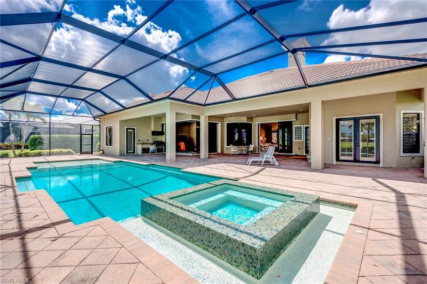 Welcome to Vineyards Venezia Grande Estates, where a distinctive, majestic gated-entry leads you to a prestigious enclave of 24 custom estate homes on this private brick paved cul-de-sac. Built in 2015, this timeless architectural masterpiece offers over 4,200 sq ft. of furnished, air-conditioned living space with every luxury desire met including hand-carved stone entry and 180 degrees of premium golf views on a sprawling .45 acre lot. Four bedrooms plus den, four and a half baths and three car garage, this neo-classic estate features imported marble flooring and custom cabinetry throughout, gourmet kitchen with gas stove, elegant gas fireplace, plantation shutters and two wet bars. An expansive lanai highlights the extravagant pool and spa with covered area including an outdoor kitchen for the ultimate entertaining. Impact glass throughout and a new pool cage with picture-window framing to ensure endless golf course views and blue skies above. Vineyards Country Club offers an optional private membership complete with 36 holes of Championship Golf, 12 Har-Tru tennis courts, award winning Fitness Center and a resort style pool and spa.