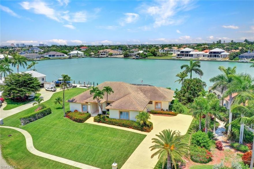 One of lowest priced bay view properties in the Estates - here's your chance to own 0.48 acres on Frederick's Bay in the estates section of Marco Island. 92ft of NEW SEAWALL in 2019. This is a perfect spot to renovate and make it your own over 3000sqft of living area, 4-bedroom and 4.5 baths. This Slocum Christian house was built with the future in mind with 8ft interior doors and glass transoms, 10ft ceilings and crown molding throughout and a soaring 18ft vaulted great room. Formal and casual dining spaces, open kitchen and living room concept, built in entertainment unit complete with wet bar overlooking wide water views. Covered lanai area with large pool and integrated spa, expansive backyard with plenty of green space and path leading down to the water. Two car side entry garage with large driveway. Must see to appreciate, being sold AS-IS.