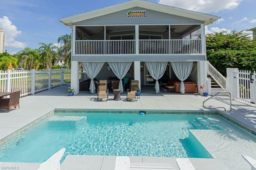 2 FULL LIVING SPACES WITH APPROX 2100 SQUARE FT AND 5 MINUTE BOAT RIDE TO THE GULF OF MEXICO at a spectacular price!!  This beautiful 2 story dream home features  4 bedrooms and 3 full baths, a stunning pool with a water feature and a sun deck. Each level is equipped with spacious kitchens, stainless steel appliances, 2 spacious bedrooms, laminate flooring and impact resistant windows.  Relax on your large screened in porch with the coveted Southern exposure for spectacular sunsets, or on the covered lanai below.  Take in the sun in the oversized custom pool with sun shelf, and equally large sun deck.  Located in the exceptional enclave of Estero Bay Shores and close to shops and restaurants.