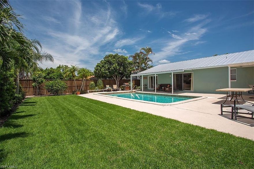 Beautifully updated Southern exposure POOL home in the heart of Naples with NO HOA fees and within a short distance to Seagate beach and the shopping/dining venues of Waterside Shoppes. Offering a spacious great room design and expansive outdoor living area that is meticulously maintained with zoysia grass. This home features a new metal roof, a masterfully renovated kitchen area with central island, cherry wood “soft close” cabinetry, granite counters, custom lighting and high end stainless steel appliance package. Expanded master bath area with walk-in shower, spacious master closet with custom built-ins, new interior wood doors and custom trim work throughout. Other features include a combination of electric and manual hurricane shutter protection, well for irrigation with a new pump, storage room and custom privacy fence. This home is even equipped with a 50 amp plug in for a generator system that may power the entire home. Also within the A-rated Seagate Elementary School District. A must see in person in order to fully appreciate this wonderful home!