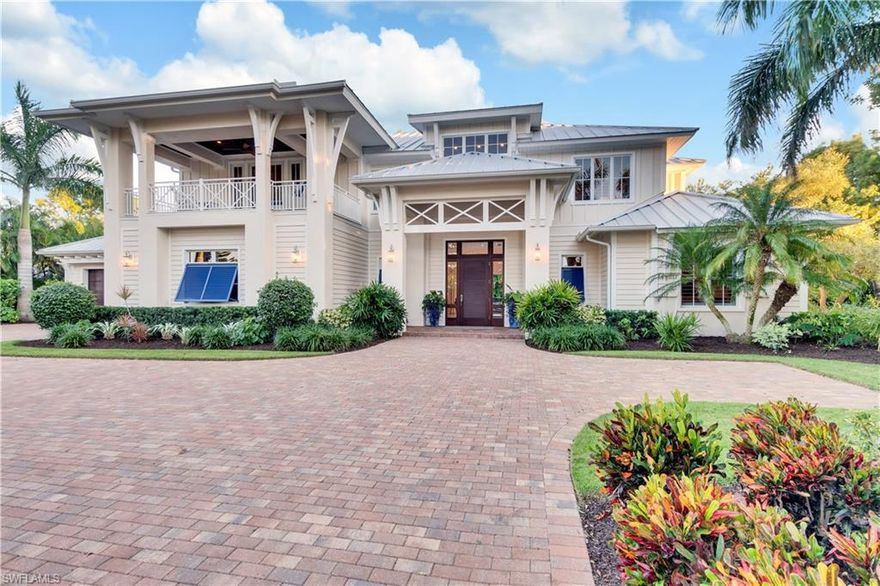 Featured on the cover of Gulfshore Life Magazine in April of 2016, this MHK-designed, Moorings home offers more than 4,200 square feet of elegant coastal living. This fully furnished, turn-key home is built on the concept of optimizing indoor-outdoor living. Large, pocketing sliders open to expose the open-concept great room to SWFL outdoor living at its best. With full Southern exposure, the outdoors boast a beautiful summer kitchen, stunning pool and spa, gas fireplace, and outdoor entertainment lounge. Fully fenced plus lush foliage provide the ultimate backyard privacy. Inside, the ground floor owner's retreat offers two large walk-in closets and spacious master bath and bedroom. The kitchen is a chef's dream with gas Wolf range, Sub-Zero fridge, and wine cooler, and a spacious island for all of the family to gather. The garage space is under air and a new Kohler automatic generator was recently installed. Just a short stroll from the Gulf, the owners of this estate will enjoy access to the private Moorings Beach Park with this address's membership eligibility. All you need to enjoy this season, is your toothbrush and your bathing suit.