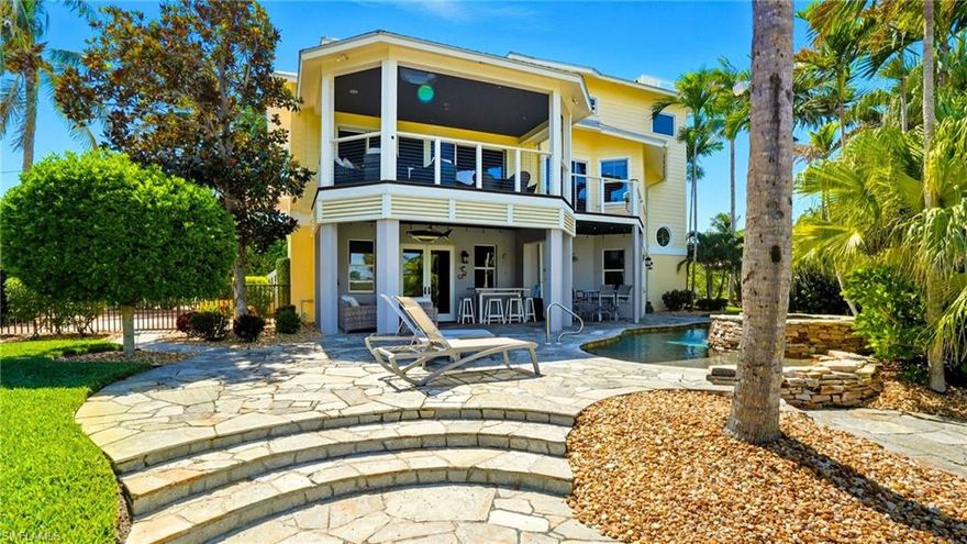 Tucked away at the end of Dundee Road, this remarkable estate offers a rare blend of total privacy and uncompromising luxury, with 210 feet of prime water frontage. Designed for the discerning waterfront lifestyle, the property features a private elevator servicing all three levels, a covered 12,000 lb. boat lift, and two docks along the expansive seawall, ensuring effortless access to the open water. Outdoors, the home unfolds into a resort-style sanctuary—a lushly landscaped backyard oasis with a stunning pool, expansive decks crafted from Brazilian hardwood, and a covered lanai with tray ceilings and western exposure for breathtaking sunsets. Full-wall sliding doors seamlessly merge indoor and outdoor living, creating the perfect backdrop for entertaining or unwinding in total tranquility. Inside, no detail has been overlooked. Scraped walnut flooring runs throughout, complemented by exquisite finishes and custom craftsmanship. The chef’s kitchen is both functional and beautiful, featuring custom cabinetry with rattan insets, leather-finished marble countertops, a Viking gas range, and premium appliances. The master suite is a private retreat with a spa-inspired bath, including a steam shower, heated floors, and elegant vanities. Family-friendly details, like custom bunk beds, balance sophistication with comfort. Modern conveniences elevate the home, from motorized shades and whole-home automation to a state-of-the-art security system and impact-resistant doors and windows. A widow’s walk crowns the estate, offering panoramic 360-degree water views, while a 1,000-gallon in-ground propane tank and whole-home generator provide peace of mind. Remote automation extends even to the pool and utilities, ensuring effortless living. Every element speaks to thoughtful design and enduring quality—solid-core doors for security and soundproofing, and a striking mahogany front door that makes a lasting first impression. From its architectural sophistication to its premier location, this estate embodies the pinnacle of exclusive waterfront living. Whether hosting, relaxing, or spending a day on the water, it offers the ultimate in privacy, comfort, and timeless elegance.