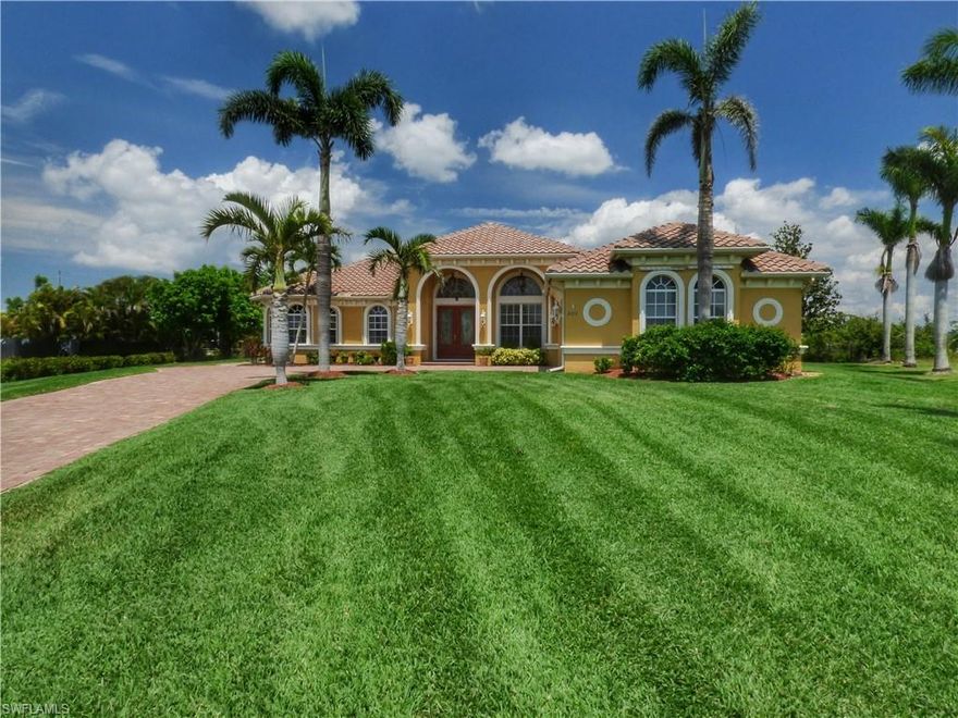 Not in a flood zone! With 2528 sq.ft. of living space, a large pool area, and almost a 1/2 acre of beautifully manicured land, you will enjoy what many others in Cape Coral don't, which is the comfort of a large home, AND yard twice as big as most others. Inside you will find many upgrades and high end features such as volume and tray ceilings, high end cabinetry and granite countertops. Each room, including the Owner's Suite, is spacious, with walk-in closets. The Owner's bathroom has a jetted tub, tiled walk-in shower, water closet, dual sinks, and a vanity desk. One bedroom is an "en suite", perfect for guests who enjoy privacy. The den could be a home office/4th bedroom. The flooring consists of high-end travertine tile and bamboo wood floors. Open your "disappearing" sliders, and this is where Florida living comes alive. A large, covered area with plenty of deck space around your salt water, heated pool with "tanning ledge". Your half-acre estate is enhanced with automated sprinkler system, fruit trees, decorative fencing, a gorgeous firepit, and space for children/pets to play. More: RO system, tiled roof, 50Hz breaker box for generator. Home just appraised for $635,000.