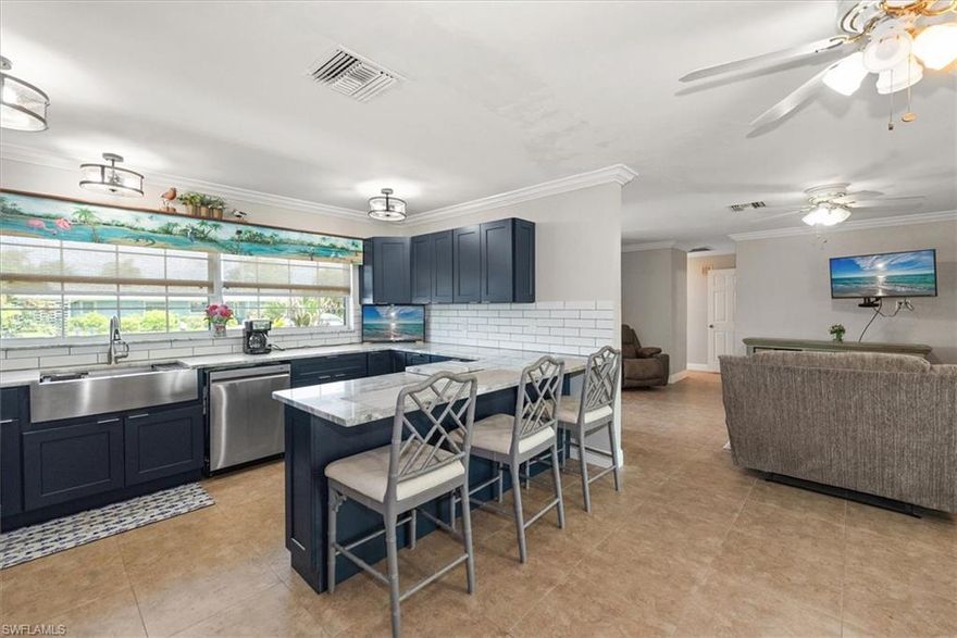 Great opportunity for Waterfront living, —this Gulf-access gem proves it. 

This beautiful, charming updated  two-bedroom, two-bath home with a two-car garage offers flexibility and opportunity. One bay can easily be converted into a workshop, flex space, or even the possibility of a third bedroom to suit your needs.  This home has been completely remodeled from top to bottom.

Set on a deep-water canal with a western facing back yard, with quick access to the Gulf and no bridges, this property is a dream for boaters and fishing enthusiasts alike. Spend more time on the water and less time getting there.  Watch the dolphin, and manatees right from your very own private extra large lanai or dock.

Inside, you’ll find a beautifully updated DREAM kitchen featuring lots of new cabinetry and granite countertops—a beautiful granite bar area, perfect for entertaining or enjoy it while relaxing at home. All new appliances, new roof, new electric and indoor plumbing, newer dock with new pilings ready for your boat lift.  Step outside to a spacious screened lanai with epoxy flooring able to accommodate a large Hot tub spanning the width of the home, ideal for relaxing, along with a dedicated outdoor fishing station for the ultimate Florida lifestyle.  Just watch the fish jump and throw your rod in!  

Located just minutes from I-75 with no mandatory HOA, (voluntary $250 annually), this property offers incredible flexibility—whether you’re looking for a personal retreat, seasonal getaway, or income-producing rental.
Enjoy low taxes, a quiet and friendly neighborhood, Situated in the desirable Yacht Club Colony, residents enjoy access to a private community boat ramp, a scenic park with horseshoes, a fire pit, barbecue area, and a charming gazebo perfect for gatherings. The community also hosts casual events, including barbecues and occasional live music, all set against the backdrop of breathtaking Southwest Florida sunsets. 

Enjoy a relaxed pace, yet conveniently located near downtown Fort Myers, shopping, dining, grocery stores, and coffee shops, this area is rapidly growing. North Fort Myers is quickly becoming the new hot spot, with exciting new development and amenities expanding all around, yet you will be in the private community or Yacht Club Colony, enjoying your own special piece of paradise!